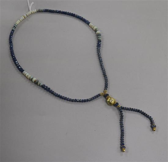 A white opal and facet cut sapphire bead drop tassel necklace with yellow metal spacers and diamond set yellow metal nugget,